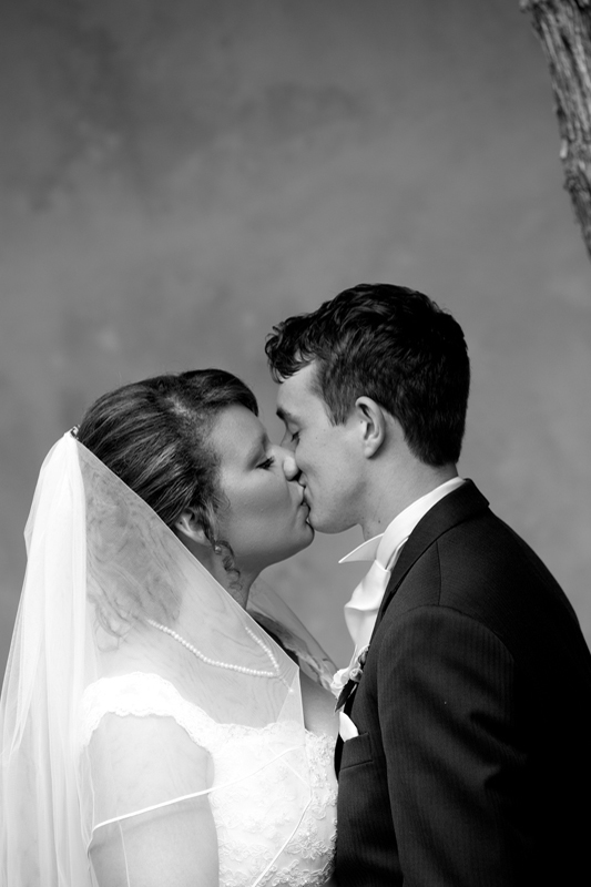 bride and groom kiss